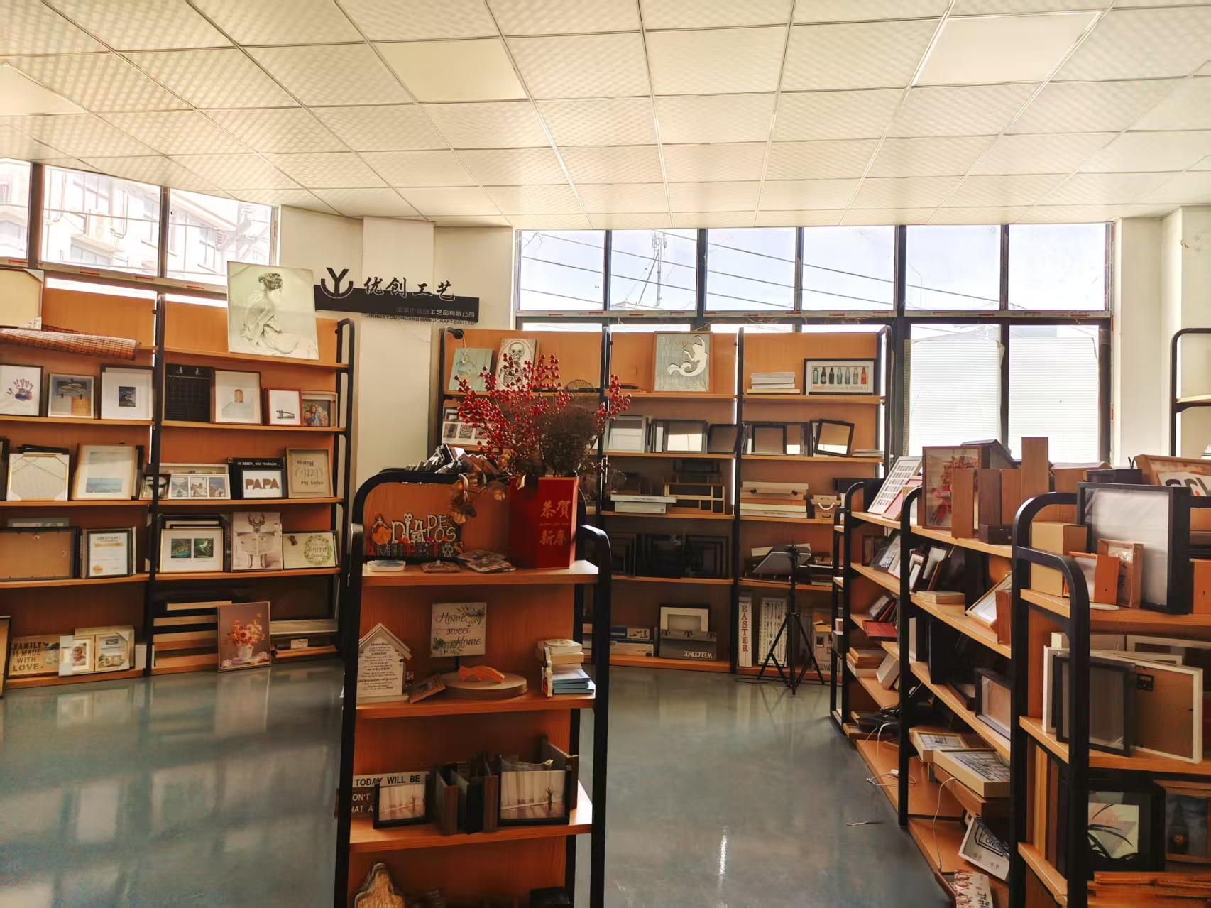 Picture frame samples and the Youchuang company sign in the sample room